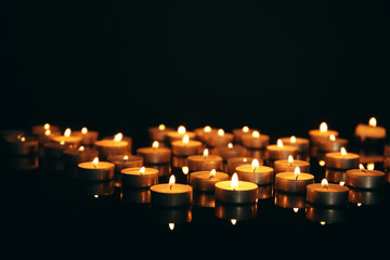 Wall Mural - Burning candles on dark background