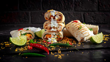 Healthy Grilled Chicken And Parsley Wraps, Loaded With Cheese, Served With Greek Yogurt Deep, Chillies And Lime Slices