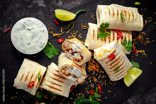 Fotomural Healthy grilled chicken and parsley wraps, loaded with cheese, served with greek