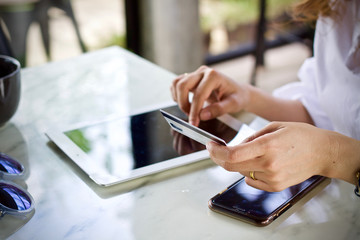 Woman using laptop smartphone paying online 