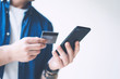 © Rymden - Man with smartphone and credit card