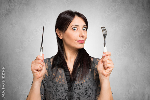 Fotomural Hungry woman holding fork and knife