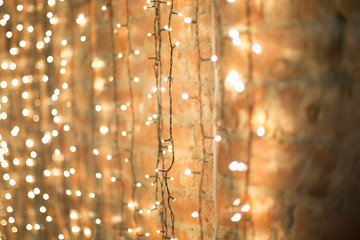 Wall Mural - Christmas electric garland on white brick wall background