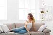 © Prostock-studio - Young redhead woman thinking on beige couch