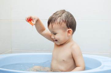 Wall Mural - Happy baby boy taking a bath