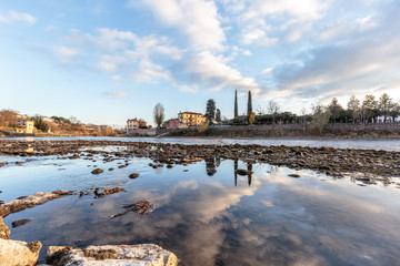 Wall Mural - reflections of the bell tower on the river adige