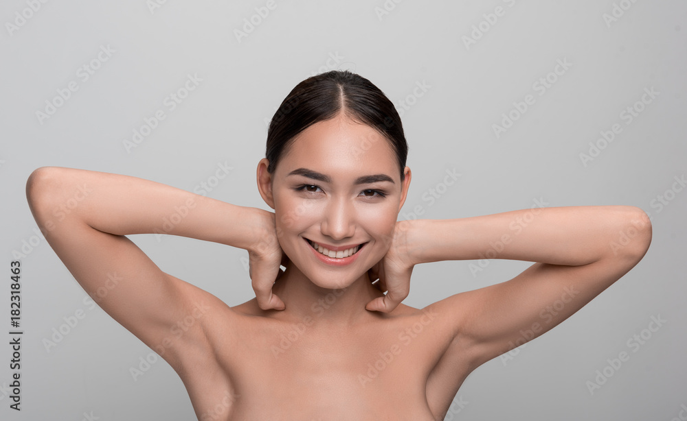 Photo Stock Beauty and skincare concept. Portrait of positive young naked asian girl is looking
