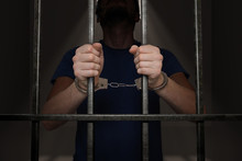 Arrested Prisoner Is Holding Bars In Prison Cell.