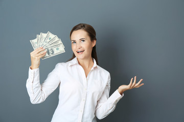 Poster - Beautiful young woman with money on color background