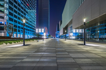 Wall Mural - night view of empty brick floor front of modern building