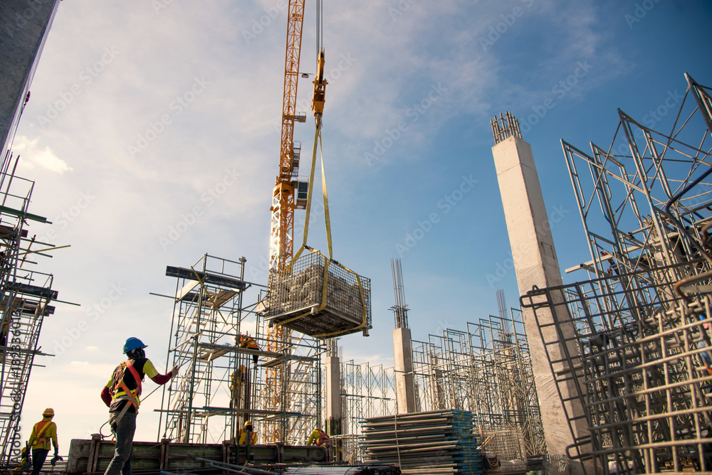 Column Installing Work group of worker in safety uniform install reinforced steel column in ...