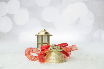 Wall Mural - christmas golden bells with red ribbons on the snow