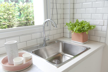 Wall Mural - Light kitchen with white counter top sink,window and grey furniture