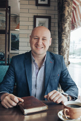 Funny businessman sitting in a restaurant