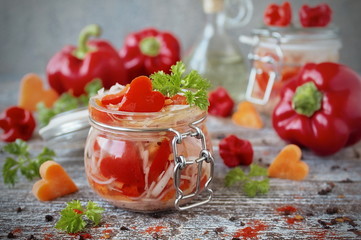 pickled cabbage with carrots and sweet pepper in glass jar