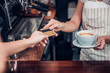 © weedezign - customer pay coffee drink with credit card to barista,Close up hand paid for to go coffee cup at counter bar in cafe,Food and drink business,billing payment.
