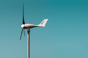 Wind turbine against the blue sky