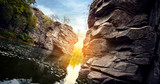 Fototapeta Tulipany - River in a stone canyon at sunset