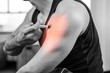 © WavebreakMediaMicro - Highlighted arm of strong man injecting anabolic steroid at gym