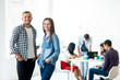 © GVS - Successful businessman and businesswoman standing in the office