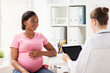 © Syda Productions - doctor with tablet pc and pregnant woman at clinic