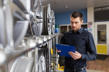 Poster - auto business owner and wheel rims at car service