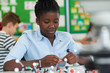 © highwaystarz - Female Pupil Using Molecular Model Kit In Science Lesson