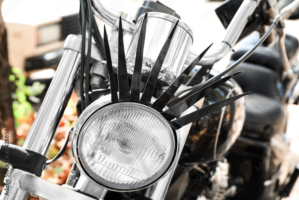 Motorcycle with eyelashes on headlight, close up