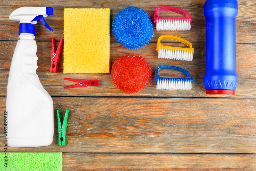 Cleaning supplies on wooden background