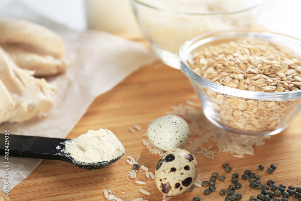 High protein food and powder on wooden board