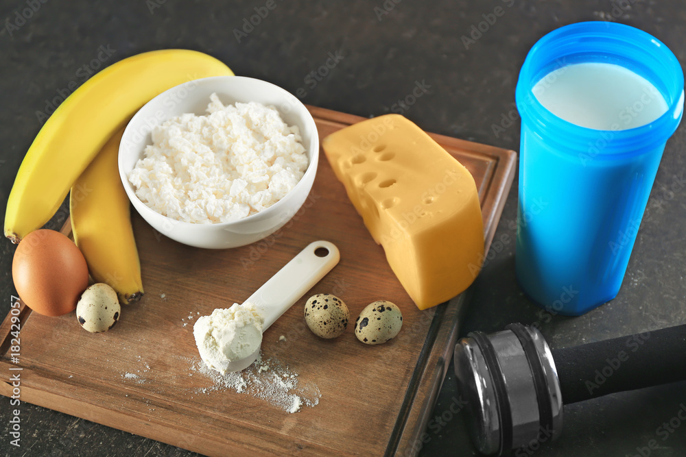 High protein food and powder on wooden board