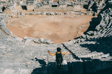 tourist with a backpack and a panorama amphitheater, travel to Turkey