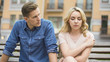 © motortion - Angry boyfriend looking at sad girlfriend, woman feeling guilty, conflict