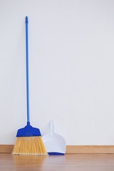 Wall Mural - Dustpan and sweeping broom leaning against white wall
