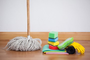 Mop and cleaning equipment on wooden floor