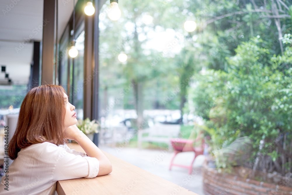 Beautiful asian girl looking through a window at cafe Stock Photo ...