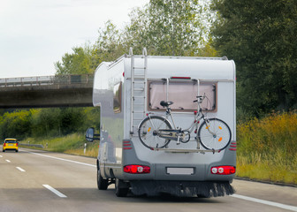 Wall Mural - Caravan with bicycle at driveway in Switzerland