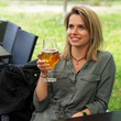 © Roman Babakin - Young smiling woman drinking glass of beer in street restaurant