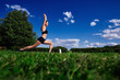 Athletic woman doing workout in the Park on the grass.