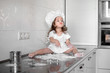 © Maxim - Little girl makes dough on kitchen with rolling pin