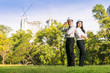 © Pises Tungittipokai - Couple civil engineer smilling while checking plan in green park