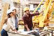 © BalanceFormCreative - Two female inspectors and architects discuss with head engineer about construction project.People at work concept.