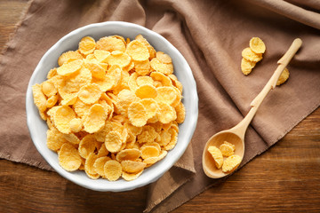 Wall Mural - Bowl and spoon with tasty corn flakes on table