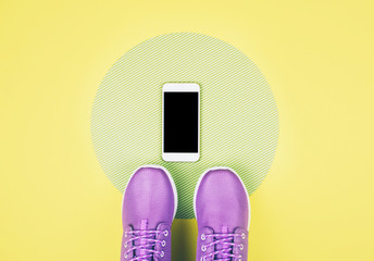 Flat lay shot of sneakers and smartphone.