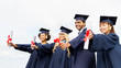 © Syda Productions - happy students in mortar boards with diplomas