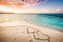 Two Hearts Drawn On A Sandy Beach By The Sea.