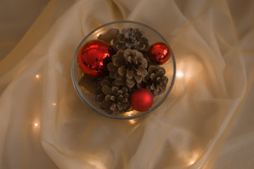 Elegant holiday decoration with natural fir cones and red globes