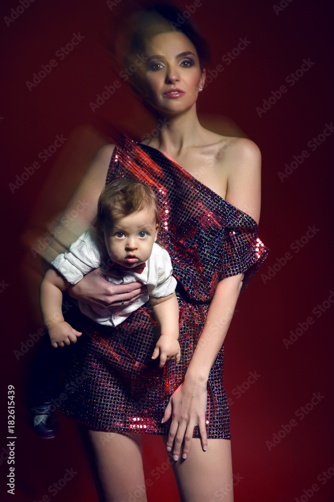 child girl sexy sexy girl in red short dress with a boy child on a red background Stock  Photo | Adobe Stock