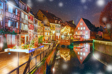 Traditional Alsatian Half-timbered Houses In Petite Venise Or Little Venice, Old Town Of Colmar, Decorated And Illuminated At Snowy Christmas Night, Alsace, France