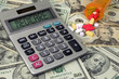 © driftwood - medicare text sign on calculator screen with prescription drugs and pill bottle on American money